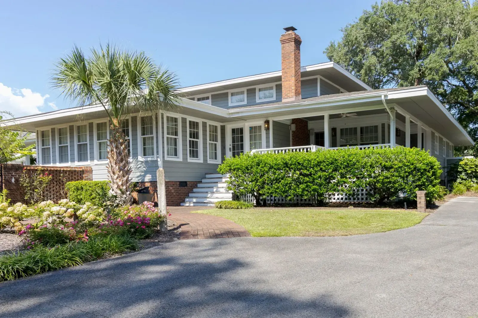 Trimmed hedges and flowering beds along a coastal bungalow